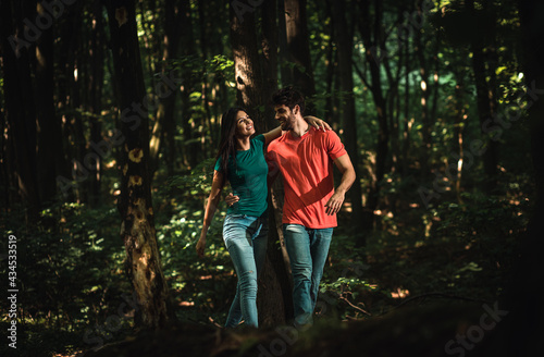 Young couple enjoys together walking through the forest. © Zoran Zeremski