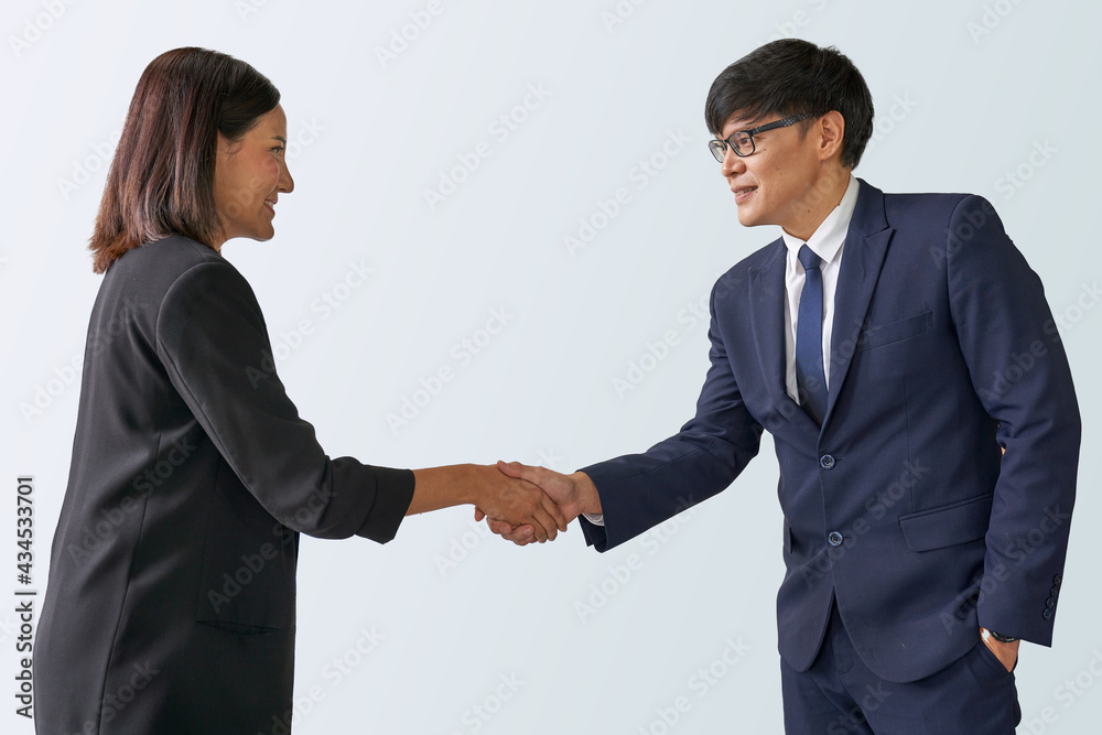 Businessman and businesswoman make a commitment with shake hand action on isolate with selective path Businessman and businesswoman make a commitment with shake hand action on isolate with selective path