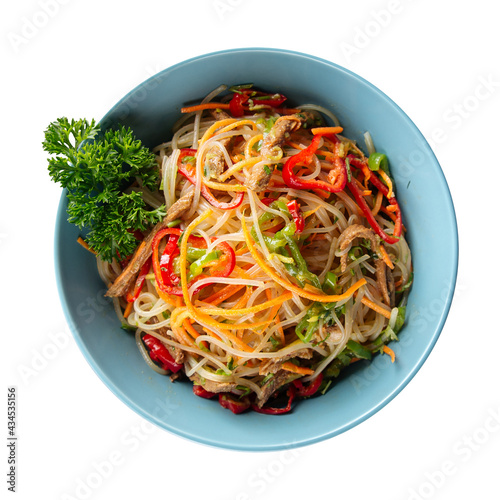 Isolated bowl of funchosa rice noodles salad with vegetables photo