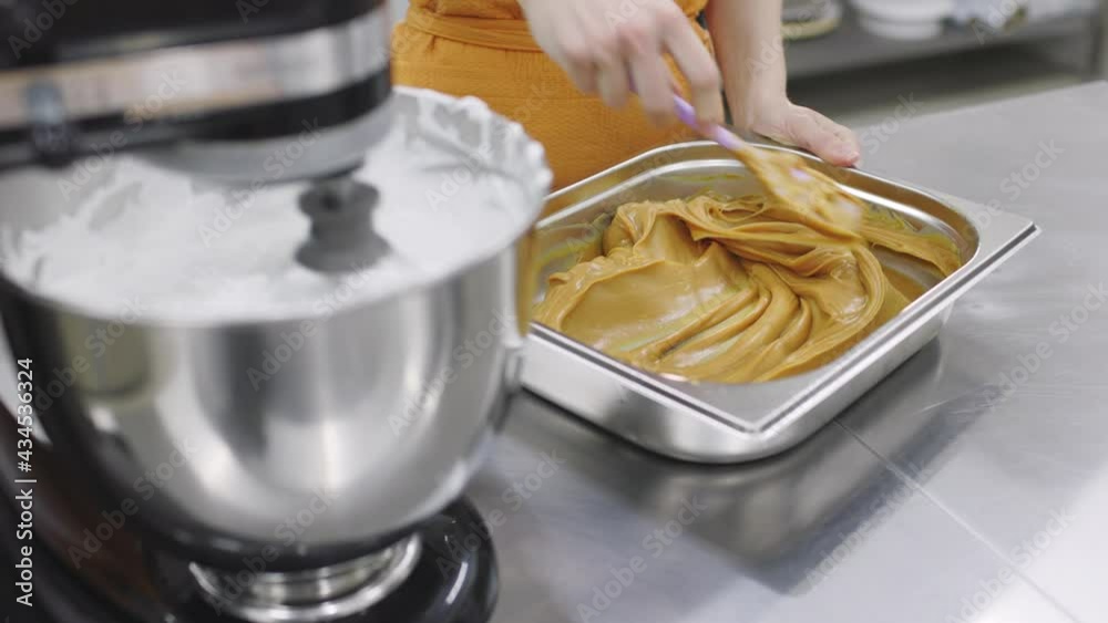 Pastry chef girl prepares fresh cakes at her small production facility Pastry chef girl prepares fresh cakes at her small production facility
