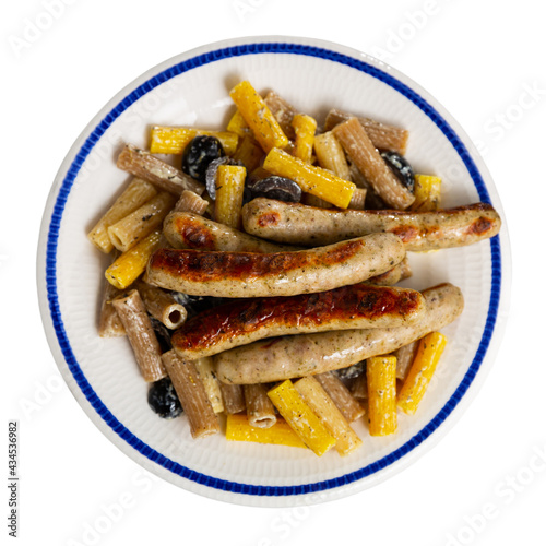 Appetizing Rigatoni pasta with hot sausages in a creamy sauce. Isolated over white background