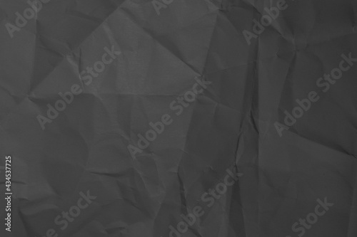 Dark gray background from crumpled paper