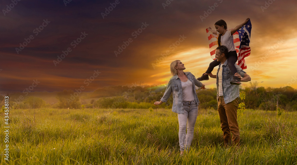 family holding up an American flag in a field. family holding up an American flag in a field.