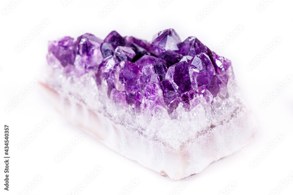 Macro mineral stone purple amethyst in crystals on a white background Macro mineral stone purple amethyst in crystals on a white background