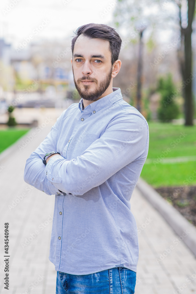 Portrait of a businessman with beard who crossed his arms on a sunny day Portrait of a businessman with beard who crossed his arms on a sunny day