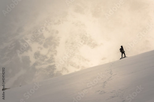 Monkh Saridag mountain, Mondy, Buryatia, Russia - 04 25 2021: a man walking in snowy mountains