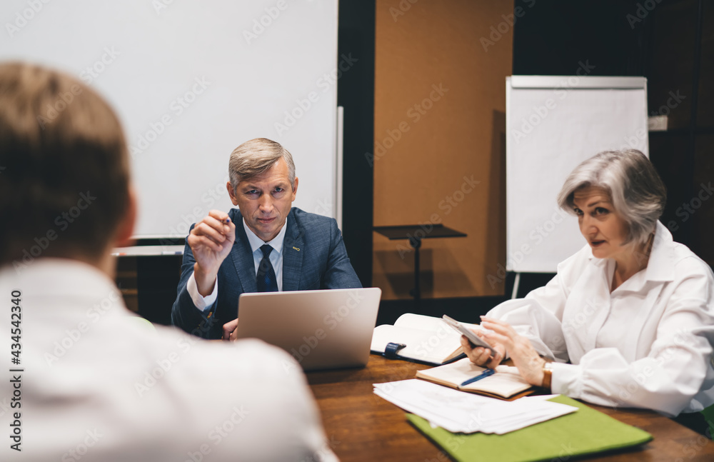 Serious business partners having meeting in office Serious business partners having meeting in office