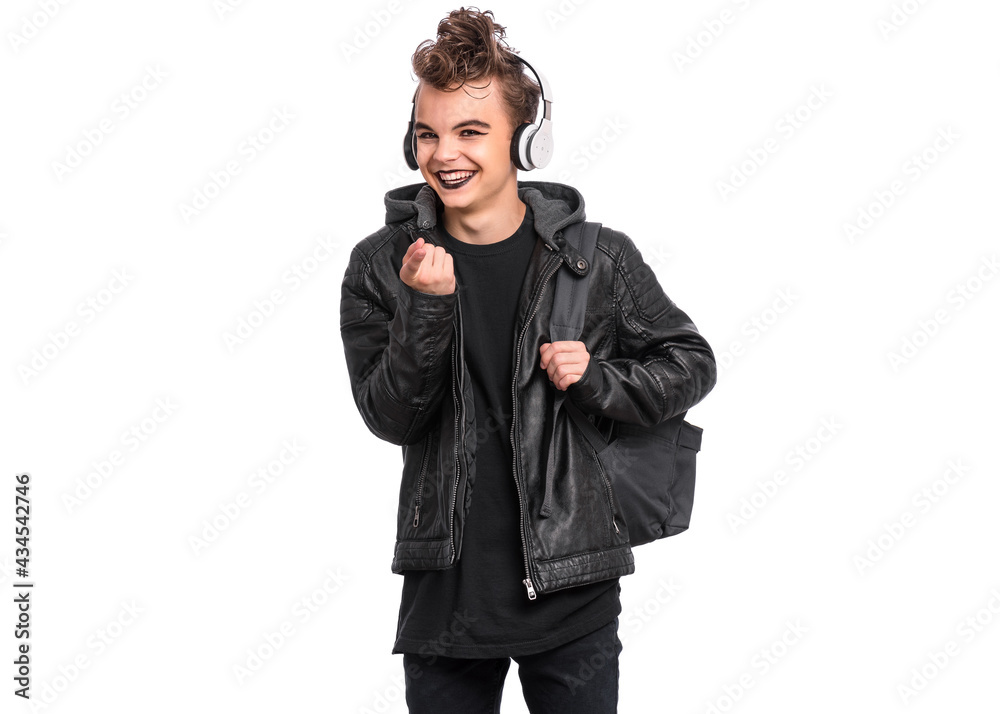 Portrait of teen boy student in headphones with spooking make-up holds bag, isolated on white background. Teenager with backpack in style of punk goth dressed in black. Problems of transitional age Portrait of teen boy student in headphones with spooking make-up holds bag, isolated on white background. Teenager with backpack in style of punk goth dressed in black. Problems of transitional age