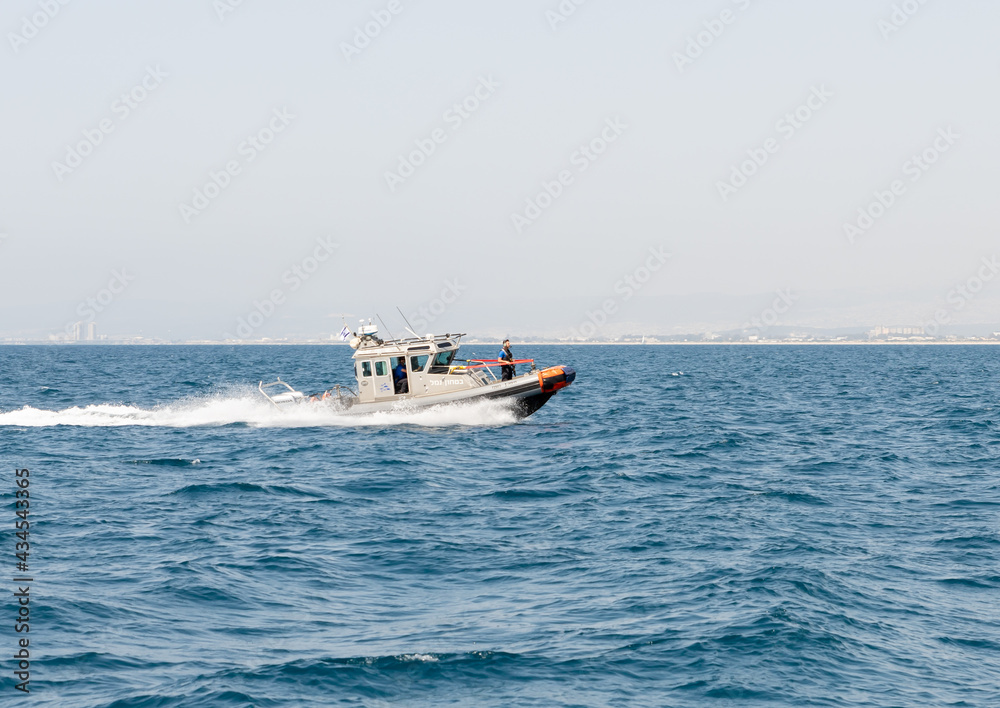 A harbor security speedboat patrols the Mediterranean port of Haifa in Israel