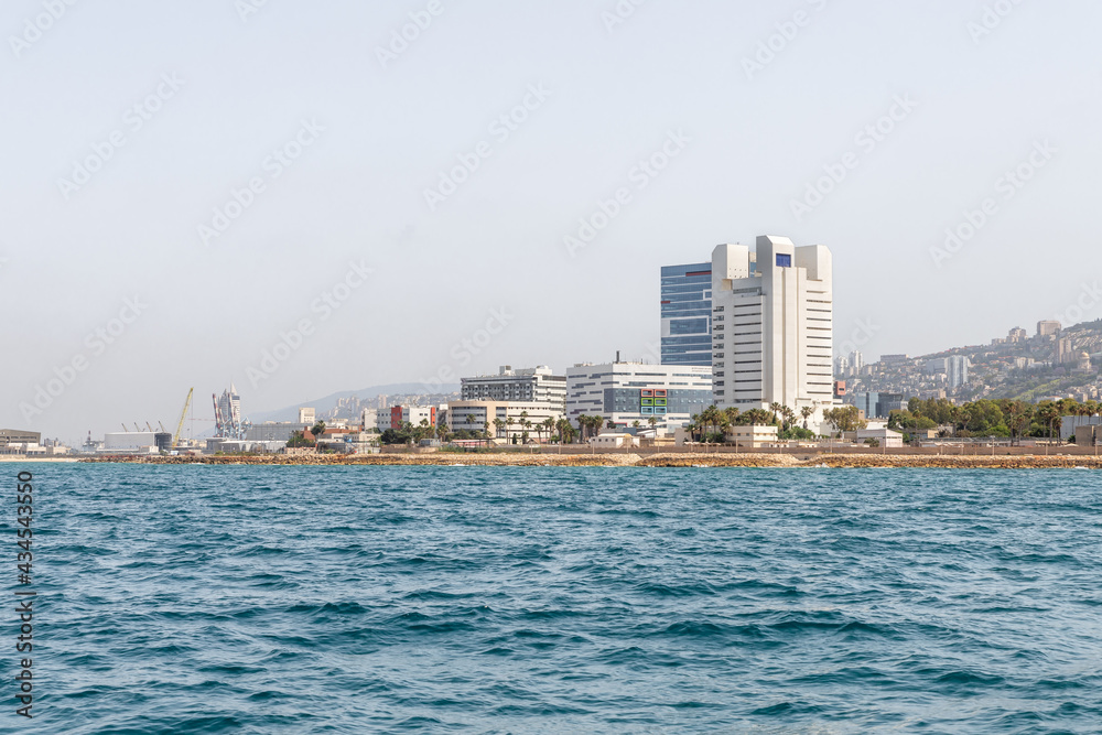 View of the embankment and the Downtown from the water area of the Haifa Bay, in the Mediterranean Sea, near the port of Haifa in Israel