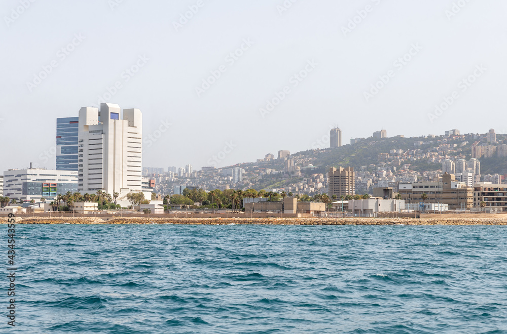 View of the embankment and the Downtown from the water area of the Haifa Bay, in the Mediterranean Sea, near the port of Haifa in Israel