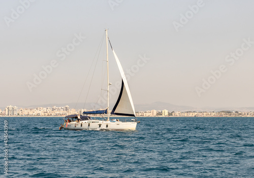 A private yacht sails in the waters of the Haifa Bay in the Mediterranean Sea, near the port of Haifa in Israel