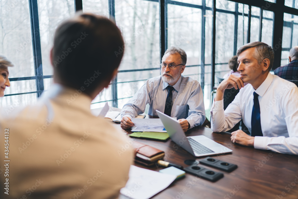 Business partners thinking and talking about new project Business partners thinking and talking about new project