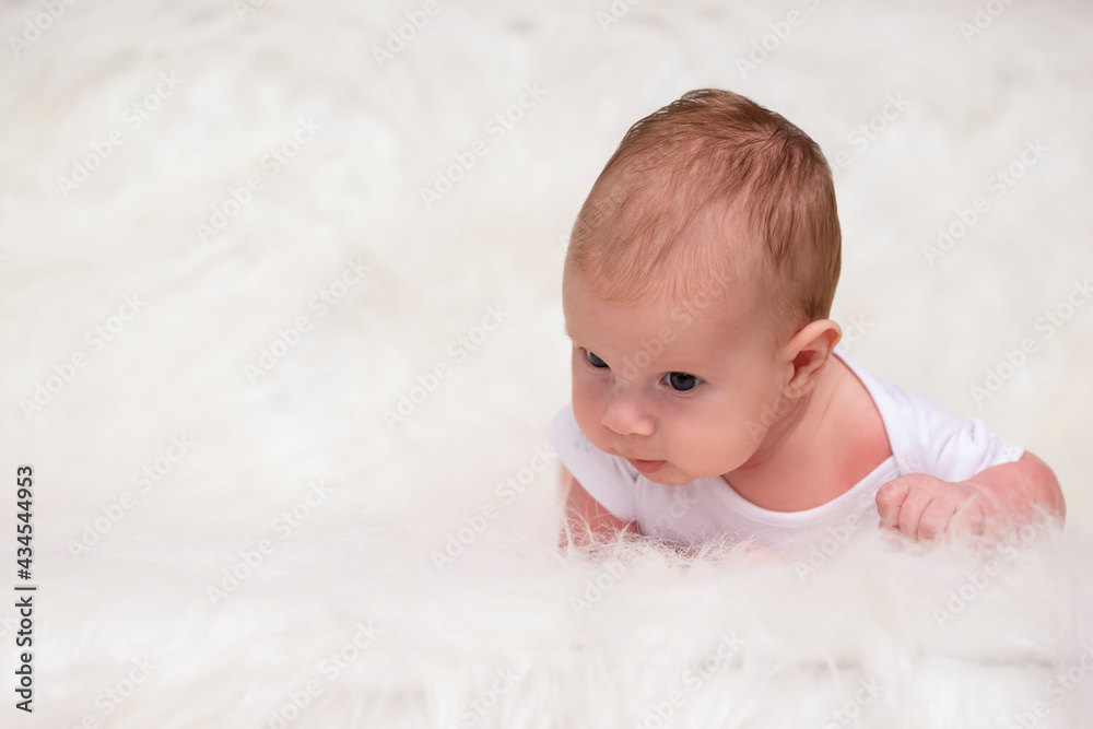 Baby Concepts. Portrait of Caucasian Newborn Boy Lying on Bed With Lifted Head. Macro Shoot.