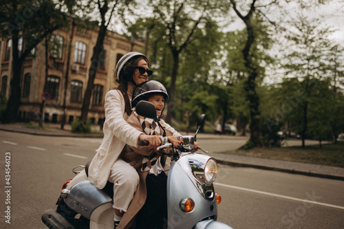 scooter riding mom and daughter in the park