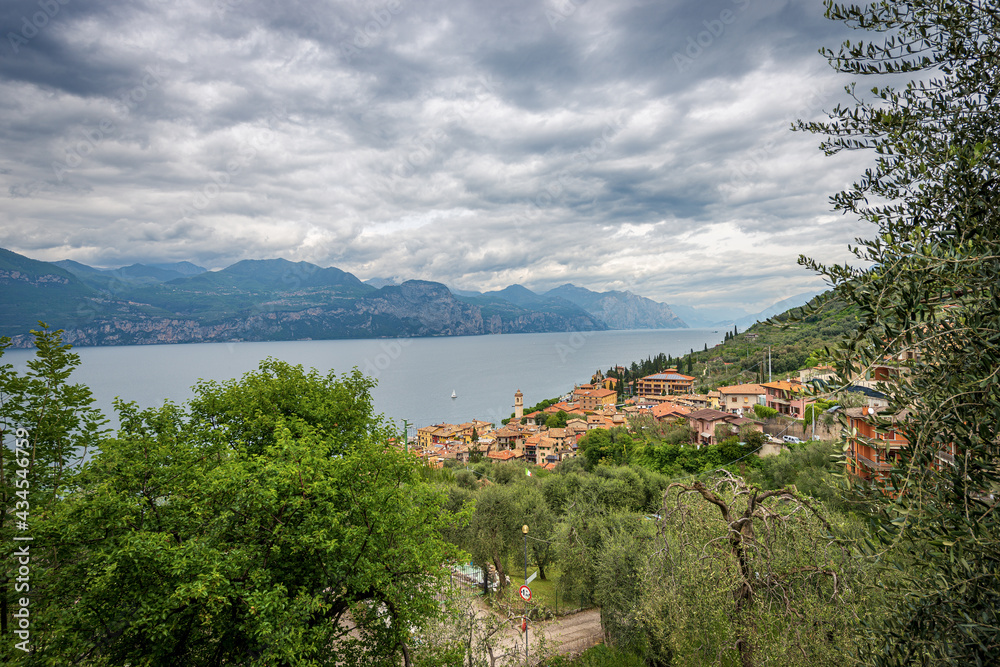 Aerial view of the Lake Garda (Lago di Garda) with the small village of Castelletto di Brenzone, Brenzone sul Garda, Verona province, Veneto, Italy, southern Europe. Lombardy coastline on background. 