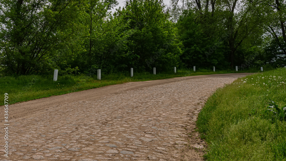 Old granite stone road, rural landscape. Natural background. Old granite stone road, rural landscape. Natural background.
