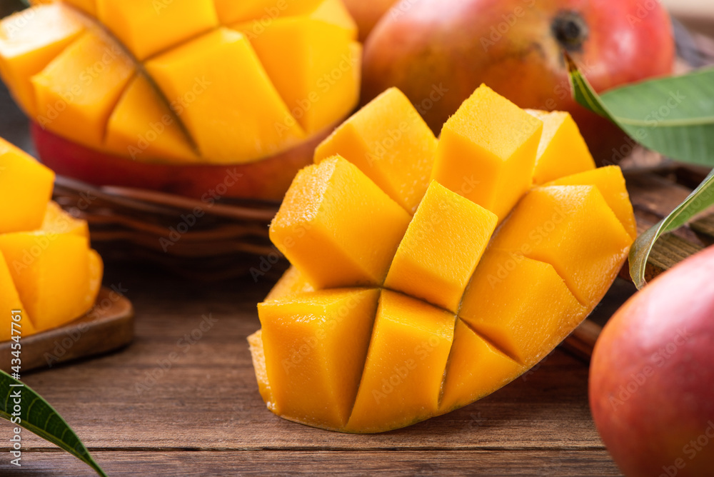 Mango. Fresh mango fruit with leaves over dark wooden table background. Mango. Fresh mango fruit with leaves over dark wooden table background.