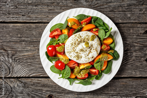 Spinach, Tomato and Burrata Salad on a plate