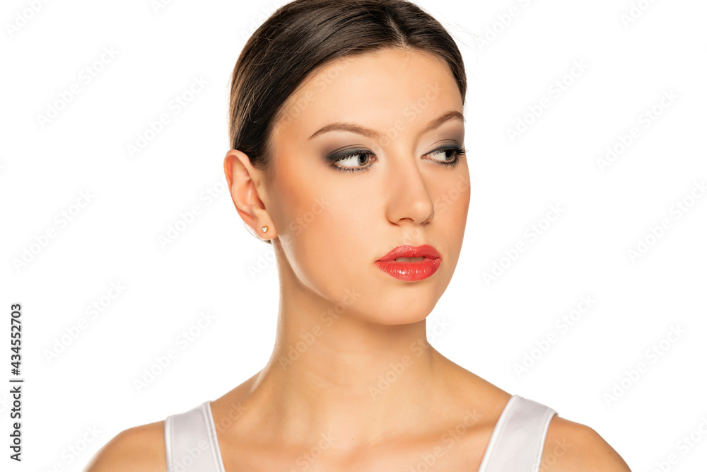 portrait of a young beautiful woman with blue eyes and makeup looking aside portrait of a young beautiful woman with blue eyes and makeup looking aside