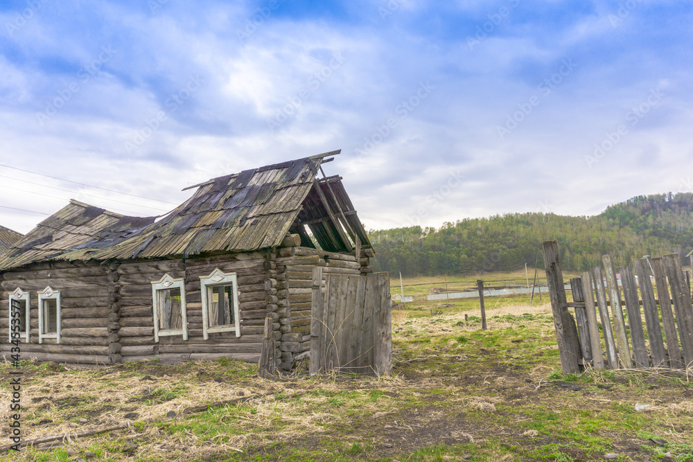 Old ruined uninhabited rustic wooden houses made of logs sunny day Old ruined uninhabited rustic wooden houses made of logs sunny day