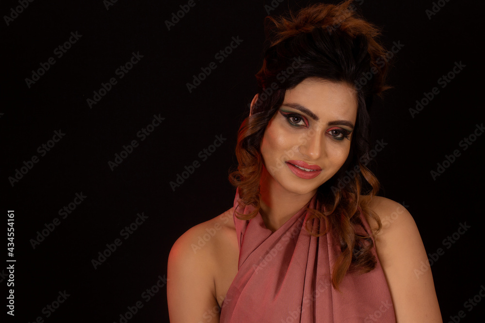Portrait of young girl looking at camera. Face close-up. Smiling Black background Portrait of young girl looking at camera. Face close-up. Smiling Black background