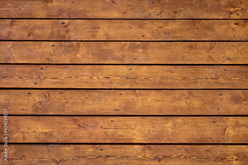 Wooden bright brown planks texture with cracks and screws, straight horizontally view