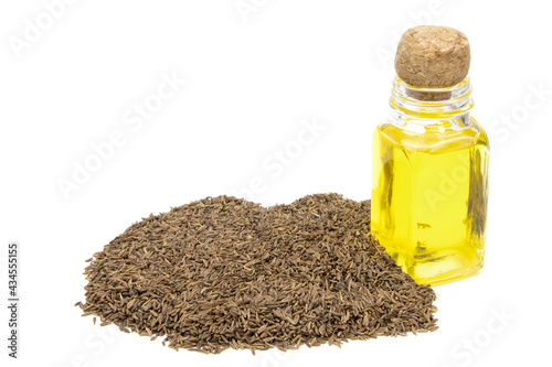 Cumin essential oil. Glass bottle of cummin oil. Caraway in a sack of isolated on a white background. Caraway in a burlap sack. Healthy food.Vegan food. Copy space
