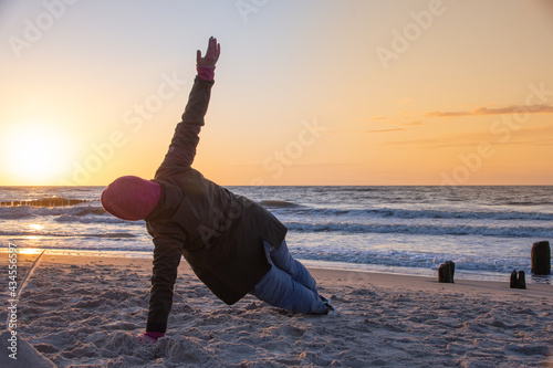 Fototapeta Naklejka Na Ścianę i Meble -  Exercises at sunset by the Baltic Sea near the city of Kolobrzeg 