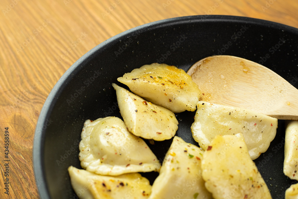 Stuffed dumplings fried in a pan. Delicious traditional dish. Stuffed dumplings fried in a pan. Delicious traditional dish.