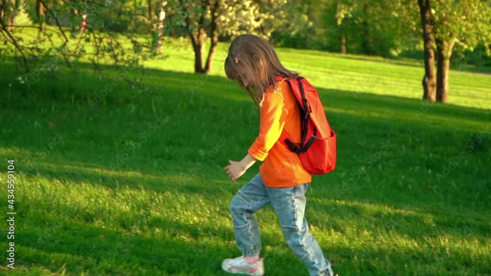 Camera movement on little child girl with school backpack runs and laughs on green lawn, in summer park. Happy preschooler fun rests after primary school outdoors. Camera movement on little child girl with school backpack runs and laughs on green lawn, in summer park. Happy preschooler fun rests after primary school outdoors.