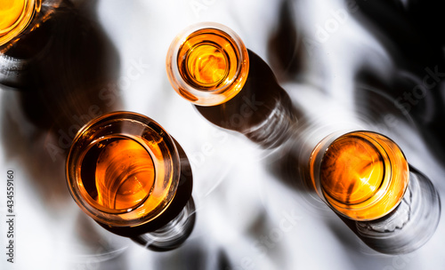 Strong alcoholic drinks, spirits and distillates in glasses: vodka, cognac, scotch, whiskey and other. White background. Hard light with shadows