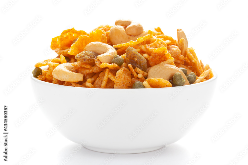 Close up of corn flex mixture Indian namkeen (snacks) on a ceramic white bowl.