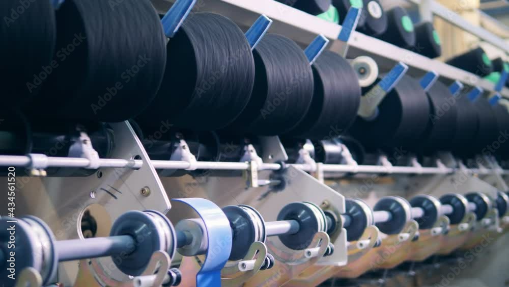 Factory mechanism is rewinding reels with threads. textile production ...