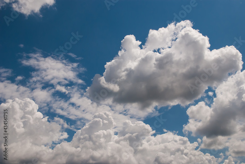 beautiful background with volumetric clouds on the blue sky