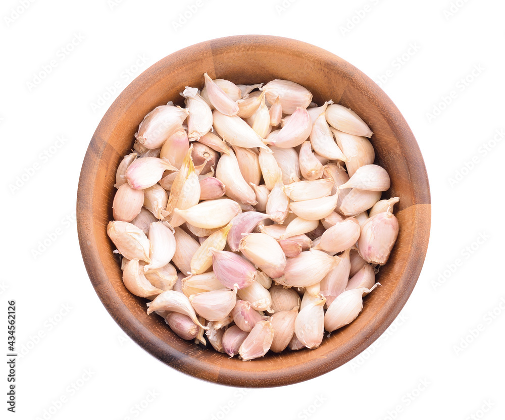 Garlic in a separate wooden bowl on white background Garlic in a separate wooden bowl on white background