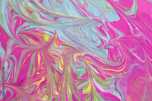 Abstract fluid art texture. A multicolored pictorial fragment of a painting. Bright acrylic drawing of pink  yellow  purple  pale green and blue shades close-up. The concept of summer mood  flowering