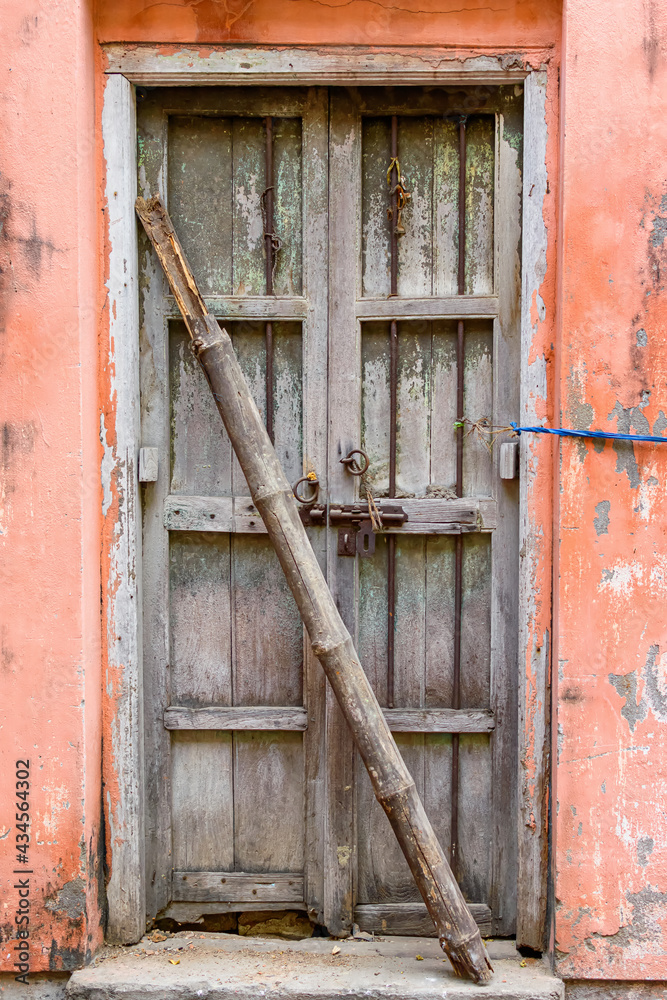 Picture of a vintage wooden door entrance of an abandoned building in north Kolkata.
