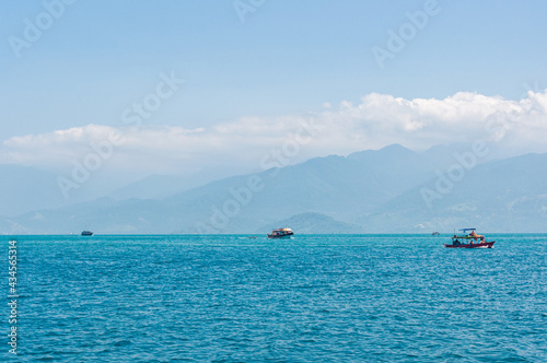Coastline scenic view with blue sky and sea. Summer vacation day at Paraty's sea.