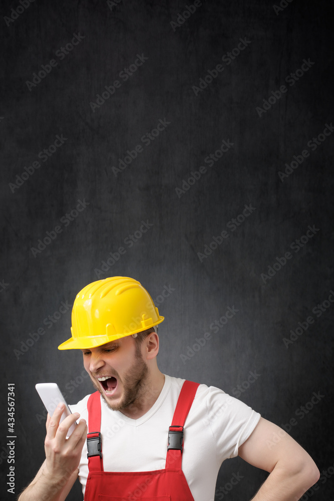 A construction worker shouting on the phone A construction worker shouting on the phone