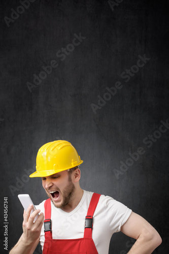 A construction worker shouting on the phone