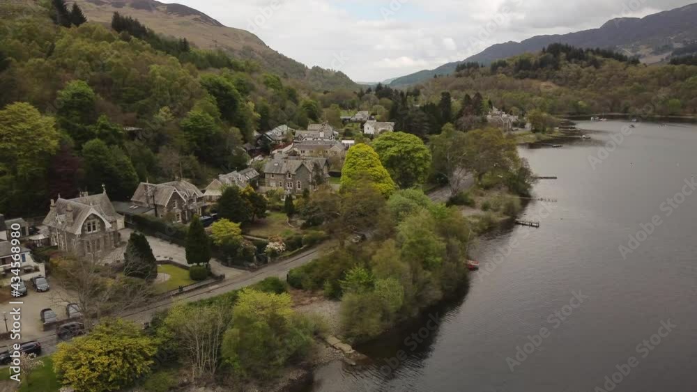 Aerial view of the Scottish town of St Fillans on an overcast spring day, Perth and Kinross, Scotland. Left to right rotating pan over the town. Aerial view of the Scottish town of St Fillans on an overcast spring day, Perth and Kinross, Scotland. Left to right rotating pan over the town.