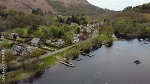 Aerial view of the Scottish town of St Fillans on an overcast spring day, Perth and Kinross, Scotland. Moving away from town whilst elevating. photo