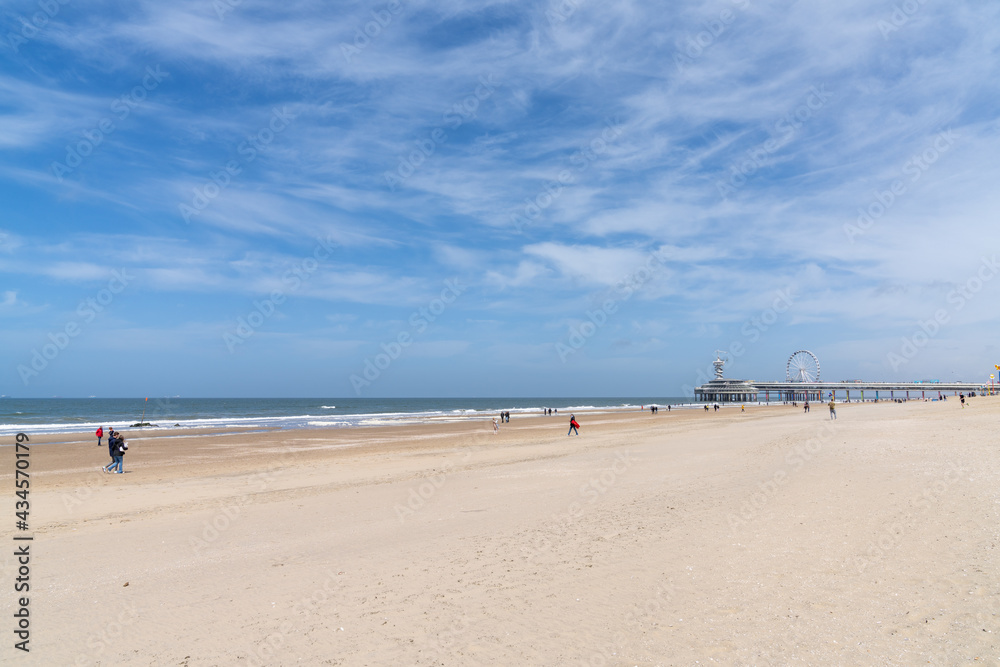 people enjoy a sunny day on the beach at the Dutch seaside resort of Scheveningen near The Hague