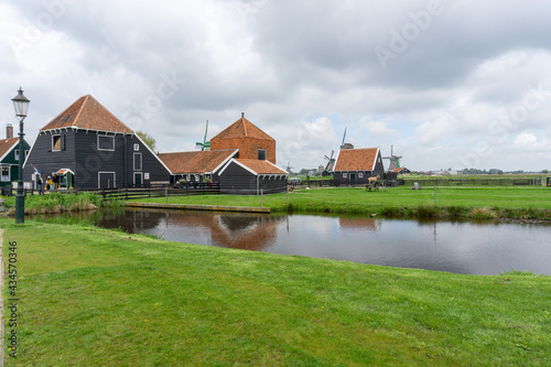view of traditional 18th-century Dutch farmhouses and windmills in North Holland Province