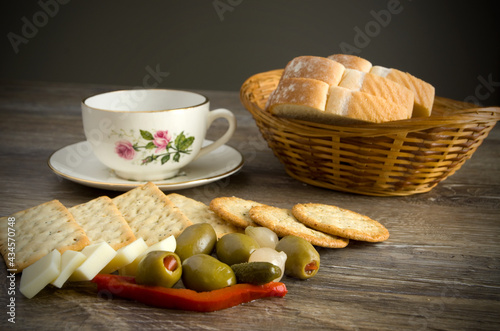 Crackers, Cheese, Olives, Bread and Coffee on Table