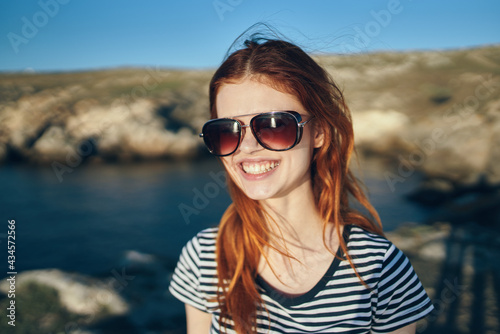 happy woman smiling on nature landscape sea river and mountains in the background