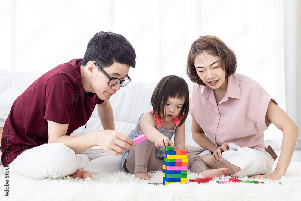 Disabled the kid and father, mother playing together with wooden toys. Disabled the kid and father, mother playing together with wooden toys.