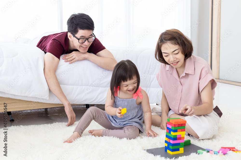 Disabled the kid and father, mother playing together with wooden toys. Disabled the kid and father, mother playing together with wooden toys.