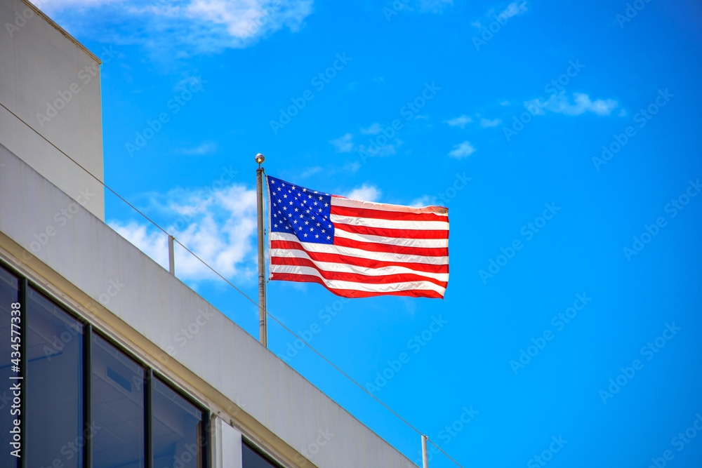 American Flag Flies on Building Rooftop